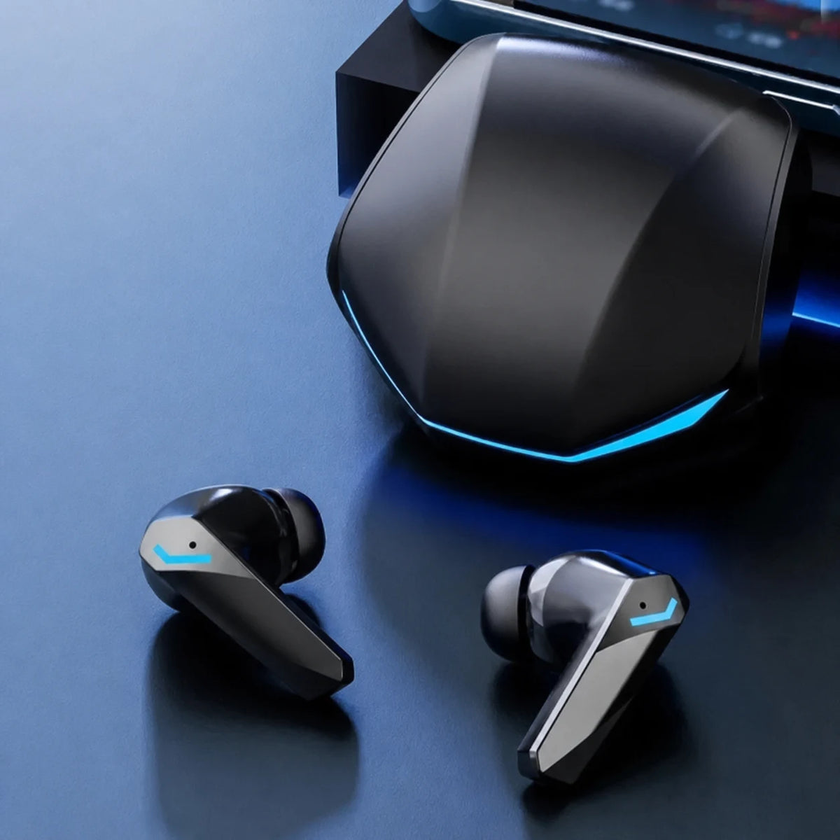 Close-up of black GM2 Pro earbuds beside the charging case.